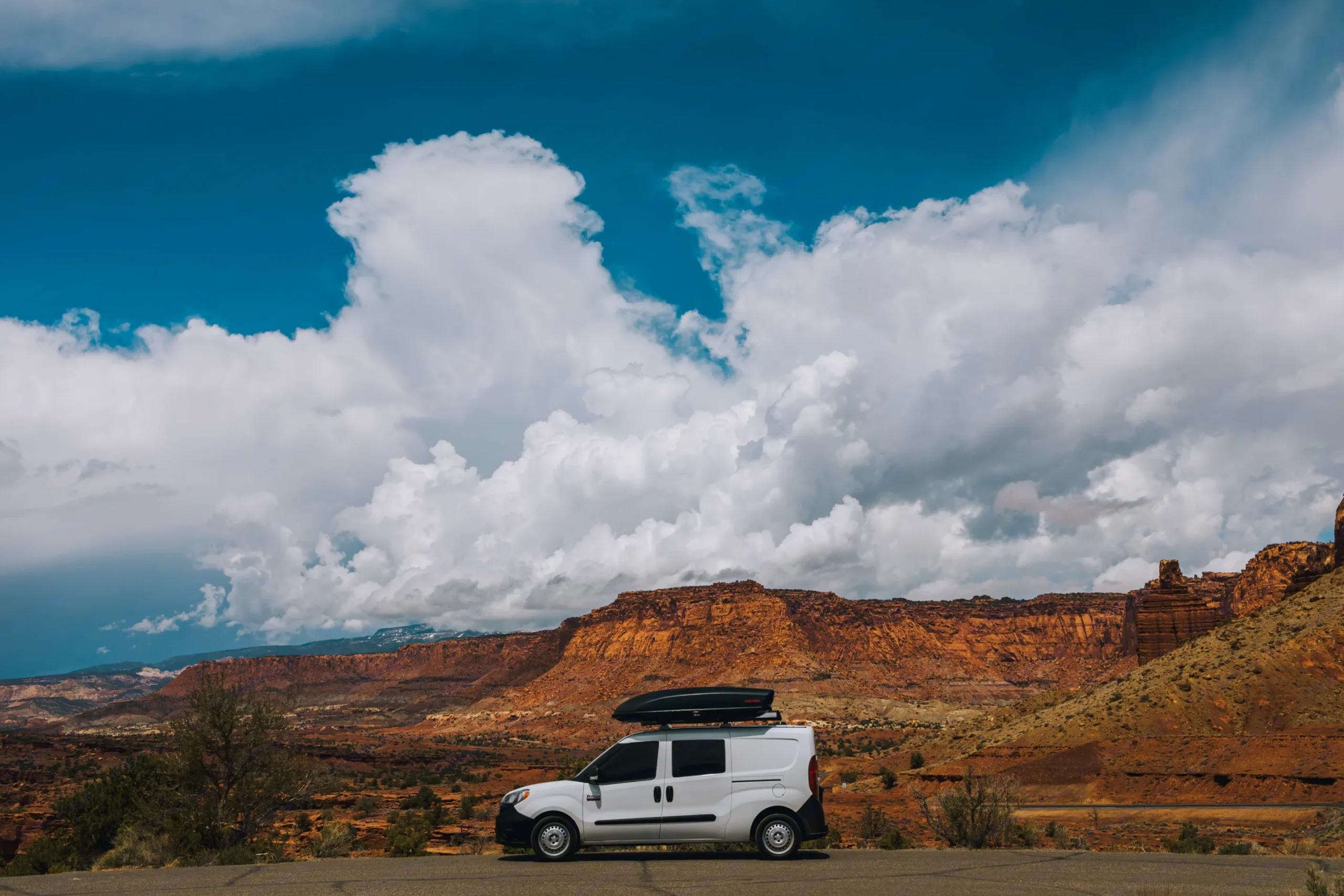 Camper van parked at Capitol Reef with dramatic cloudy sky
